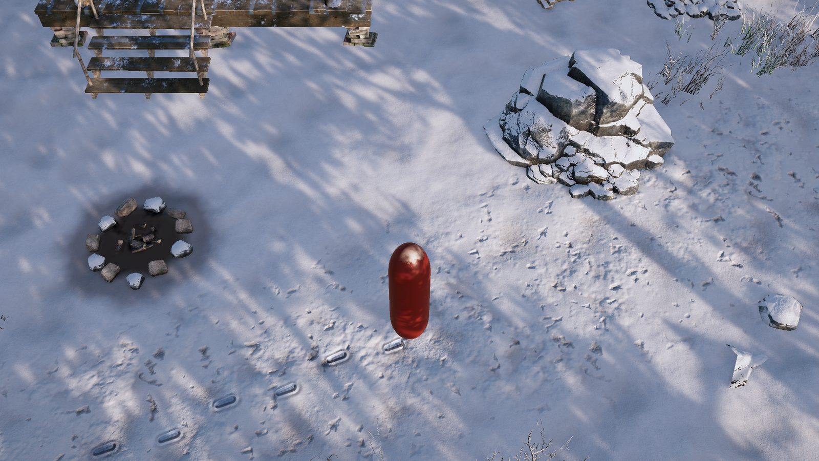 A red capsule standing on sunlit snow with a line of boot prints behind it, a campfire ring to the left and a snow-capped rock to the right.